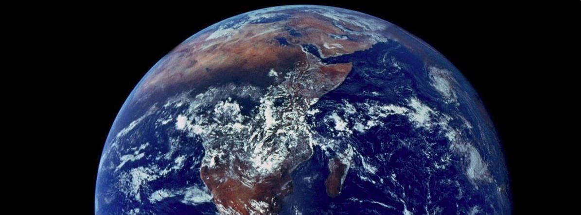 The Earth photographed from space, Africa and the Arabian peninsula under swirls of white cloud on a black sky